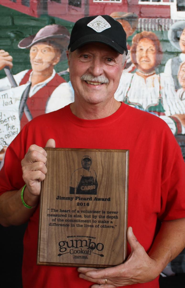 Kernis Louviere holding award at World Championship Gumbo Cookoff