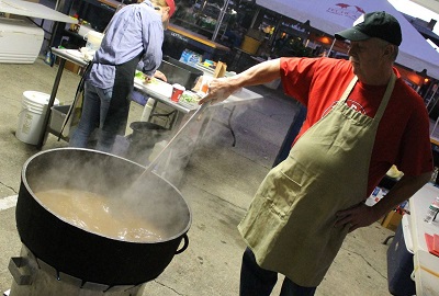 Cook stirring pot at the World Championship Gumbo Cookoff in New Iberia, Louisiana