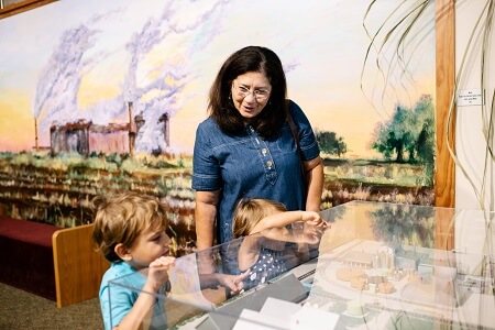 Woman and two children look at an exhibit at the Bayou Teche Museum in New Iberia.