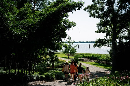 A group of women walks down towards Lake Peigneur at Jefferson Island Rip Van Winkle Gardens in New Iberia.